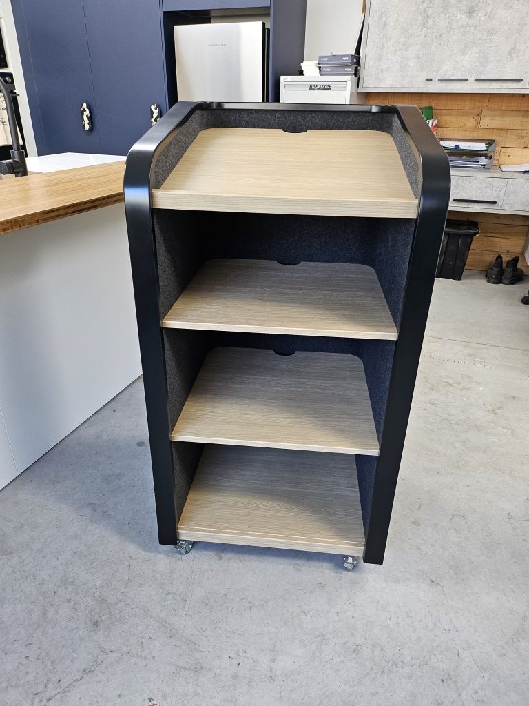 Custom-built mobile Mobile Lectern and Shelving Unit with autex lined panels, rounded black edging and timber shelving, crafted for commercial workspaces by Newton Gordge Joinery.