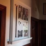 Custom timber display frame with integrated shelving and detailed mouldings, handcrafted by Newton Gordge Joinery.