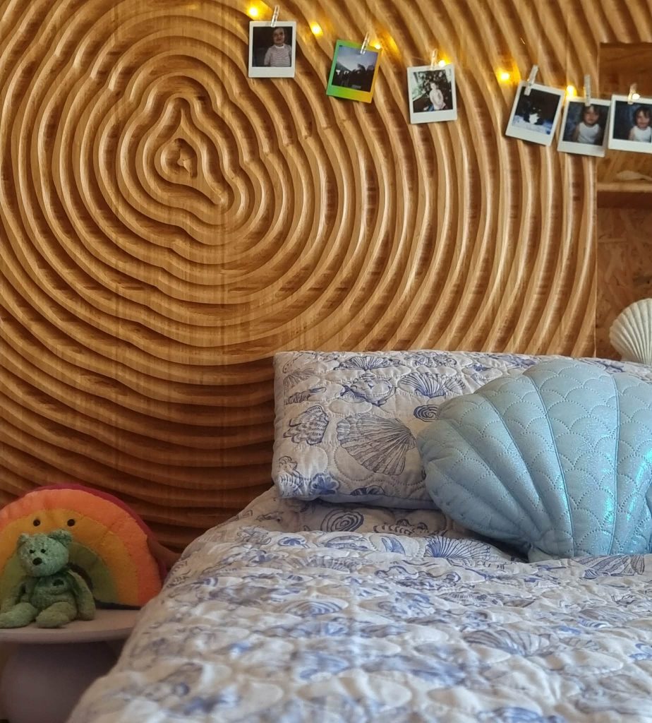 Custom CNC-carved timber bedhead with layered contour design crafted by Newton Gordge Joinery.